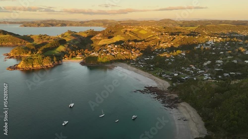 Breathtaking 4K panoramic views of Palm Beach on Waiheke Island, New Zealand, at sunset. Experience the serene beauty of the Hauraki Gulf. photo