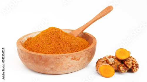 Turmeric powder or Kunyit bubuk, served in wooden bowl, copy space.