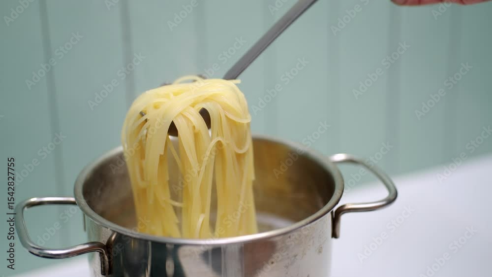 Boiling spaghetti noodles in a pot. Preparation of a classic pasta dish ...