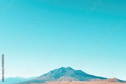 Vast, light-blue sky meets a solitary mountain