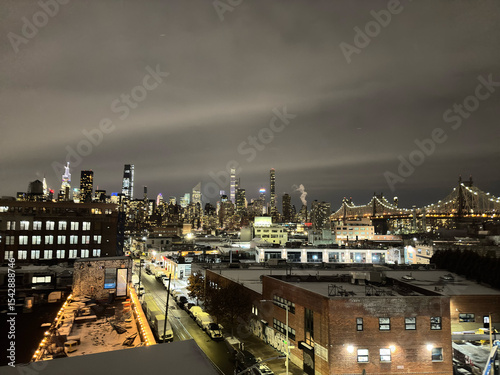 New York skyscrapers at night. High-rise buildings visible through low-rise buildings.
From the observation deck of a building in Long Island City.