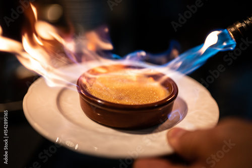 Fotografie Crème Brûlée with Caramelized Flame – Classic French Dessert with Fiery Topping