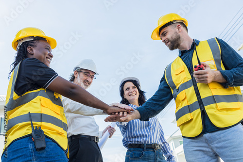 Diverse Construction engineer profession workers people join hands, Group of multiethnic company.