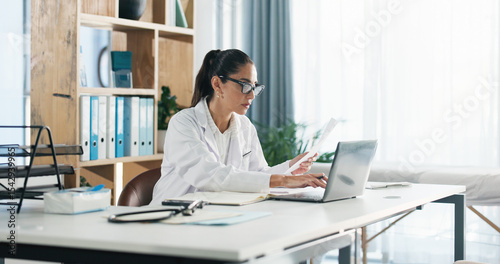 Tableau sur toile Doctor, laptop and woman with paperwork in office for clinic admin, diagnostic info or medical report