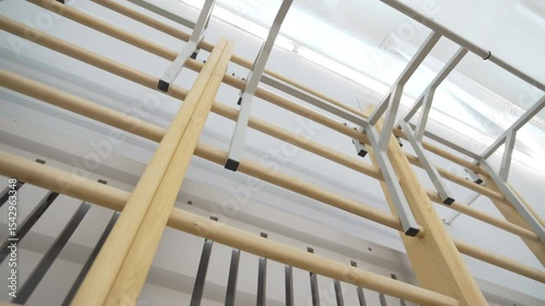 Pull-up bars attached high near gym ceiling for vertical training. Adjustable grips provide versatile support for resistance-based sessions