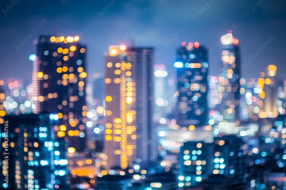 Fototapeta premium Blurred Night Cityscape With Illuminated Skyscrapers