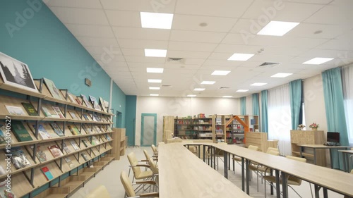 Bright school library features long wooden table for focused quiet group work and collaborative study. Space combines comfort with purpose