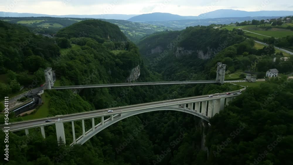 Pan drone shot of Caille Bridge and Caquot Bridge during the day with cloudy sky in Allonzier-la-Caille Cruseilles, Haute-Savoie, France Pan drone shot of Caille Bridge and Caquot Bridge during the day with cloudy sky in Allonzier-la-Caille Cruseilles, Haute-Savoie, France