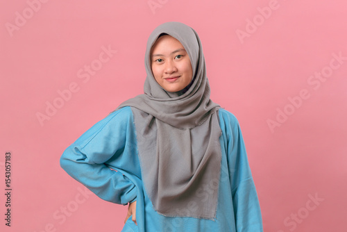 Confident Indonesian Muslim Girl in Casual Outfit with Hand on Hip, Studio Portrait