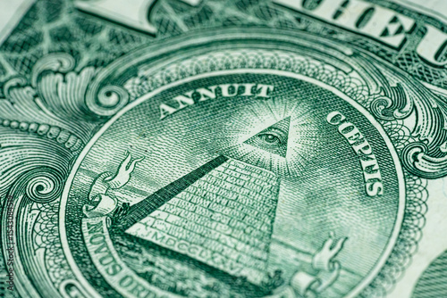 Macro of One US Dollar bill pyramid all seeing eye front side of American currency tilted 2