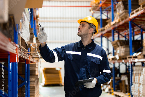 Slika na platnu Man paper warehouse worker holding tablet checking inspecting quality cardboard corrugated carton in storage