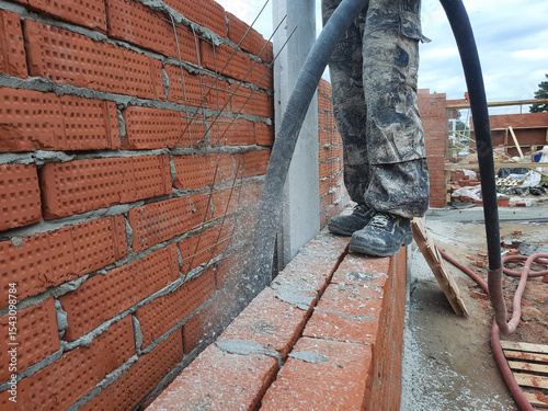 Cellulose insulation between brick wall