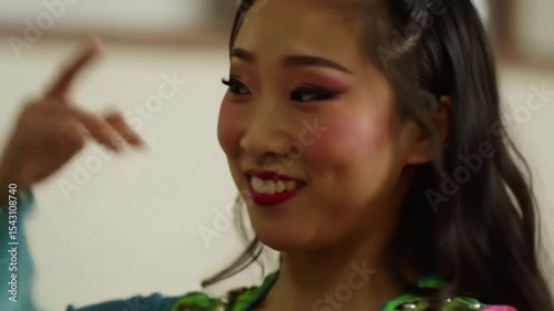 Girl is preparing to dance dance. Oriental movements, beautiful costume, dancer smiles and waves her hair. 