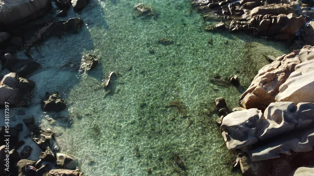 Aerial view of rocky shoreline with crystal-clear waters on La Digue Island, Seychelles paradise