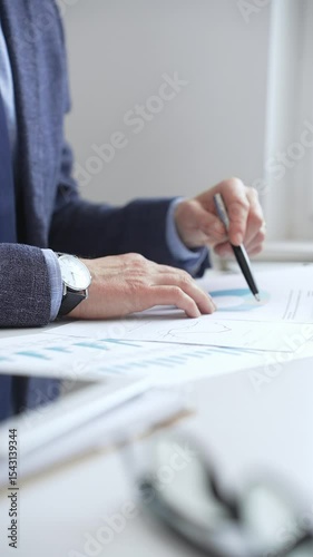 Professional analyzing financial charts on laptop, reviewing data for strategic business planning and investment optimization. Business people concept