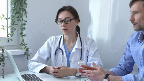 Female doctor explaining a diagnosis to a male patient, offering medical advice and support during a consultation in her office, fostering communication and trust. Medicine and health care