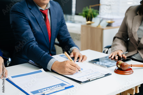 фотографія Business and lawyers discussing contract papers with brass scale on desk in office