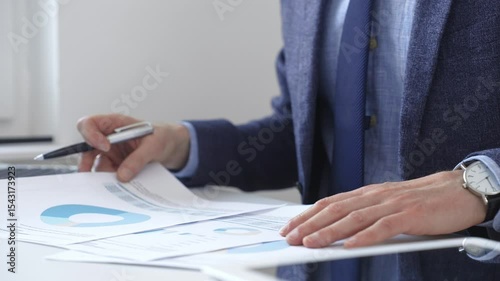 Professional analyzing financial charts on laptop, reviewing data for strategic business planning and investment optimization. Business people concept