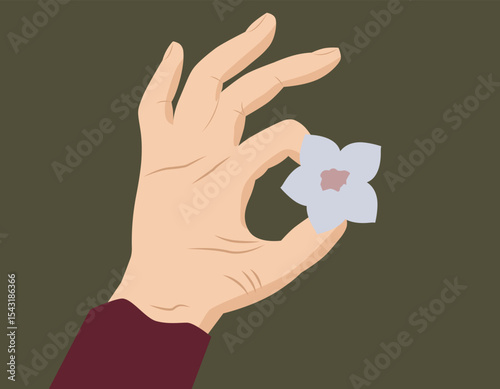 A hand holds a delicate flower. The theme is about nature, femininity, harmony and mindfulness of the moment.