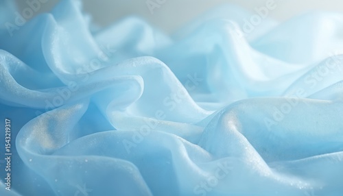 Shimmering blue organza fabric drapes. Delicate semitransparent material with aethereal texture ideal for fashion or evening wear promos. Soft flowing cloth.