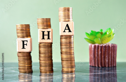 FHA - acronym on wooden cubes on stacks of coins photo