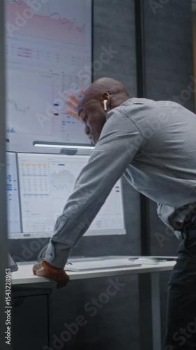 Financial Analyst Suffering from Financial Crisis, Yelling During Call, Analyzing Exchange Market Charts in Office. African American Businessman Furious About Stock Market Collapse. Vertical Shot.