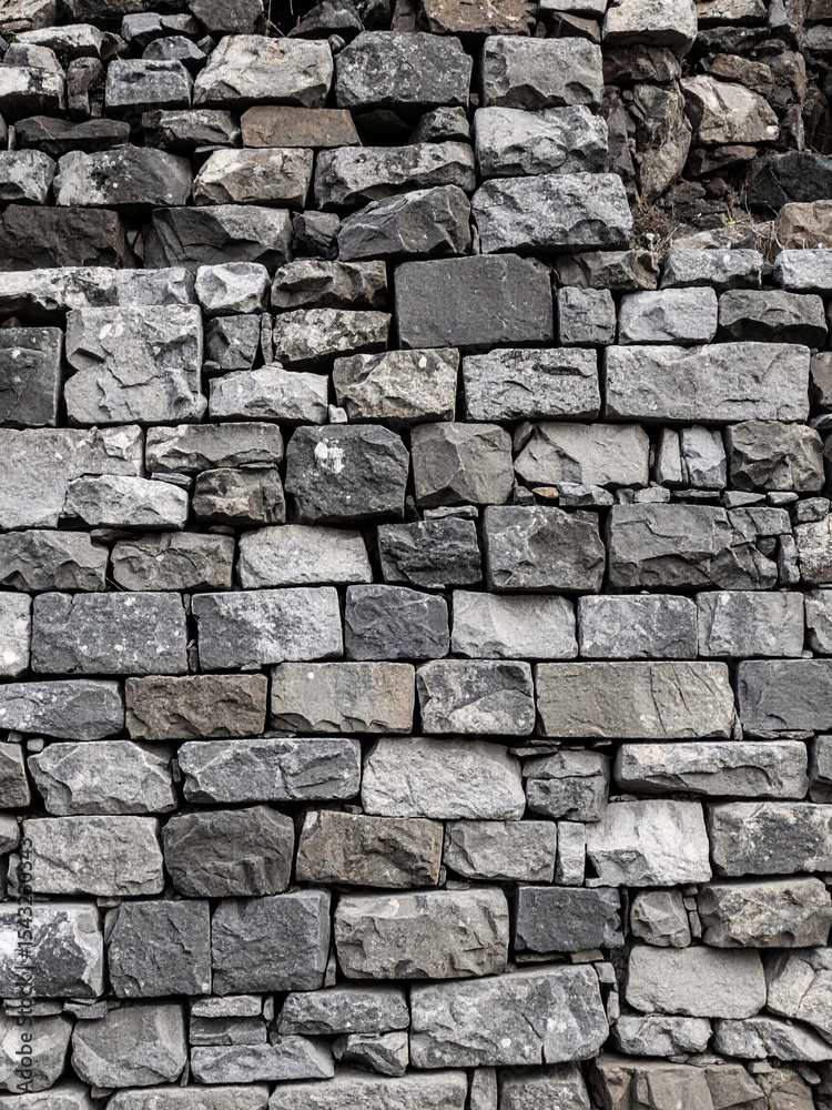 Fototapeta premium Old brown rock stone wall with rough texture pattern