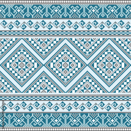 Intricate pixel design with structured diamond shapes and ornamental borders in blue and grey tones, representing traditional Thai loom art.