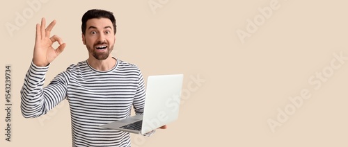 Surprised man with laptop s...
