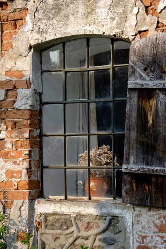 old window with bars. atmospheric. Old mill. red brick building