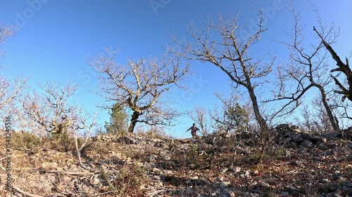 Adventurer riding unicycle through wild barren landscape