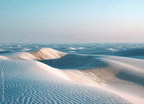 White dunes at twilight, the vast expanse of sand stretching to infinity under the dim glow of dusk. The tranquil scene captures the serene beauty and endlessness of desert landscapes. High-resolution