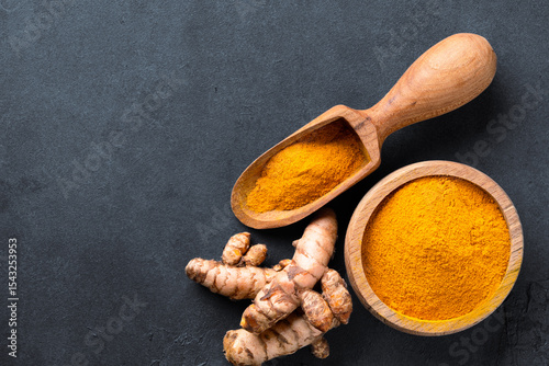 Fototapeta Naklejka Na Ścianę i Meble -  Turmeric with its magnificent orange color on a vintage black background