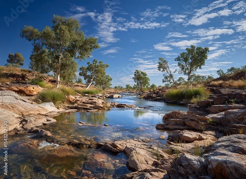 A classic arid landscape with a rocky river bed and blue sky in the afternoon sun, this photograph captures the architecture of Australia's Outback in the northwest. 