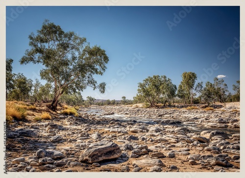 A classic arid landscape with a rocky river bed and blue sky in the afternoon sun, this photograph captures the architecture of Australia's Outback in the northwest. 
