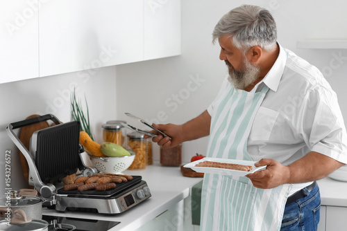 Mature man with plate of co...