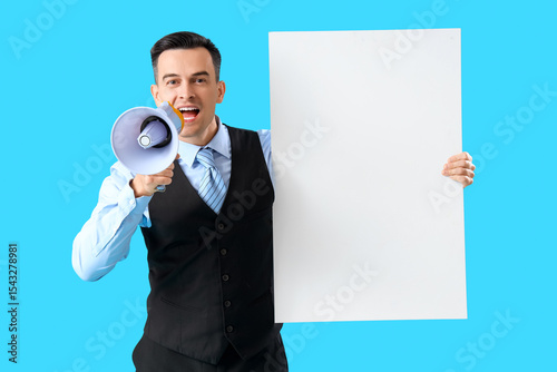 Handsome steward with blank poster shouting into megaphone on blue background