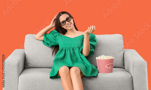 Entertainment and leisure, young woman wearing 3d glasses sitting on a sofa w...