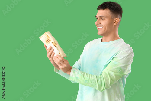 Happy young man holding del...