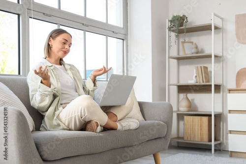 Young woman with laptop vid...