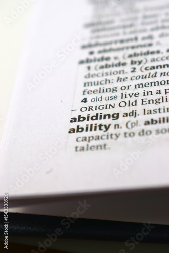 Close Up Of English Dictionary Page With Word - Abiding