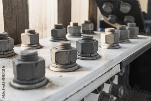Large Metal Nuts and Bolts on Steel Beam Joint in Construction Framework