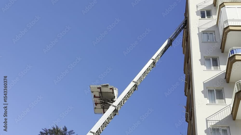 Home removal with hydraulic lift. Transporters carrying goods by elevator from the window of the building Home removal with hydraulic lift. Transporters carrying goods by elevator from the window of the building