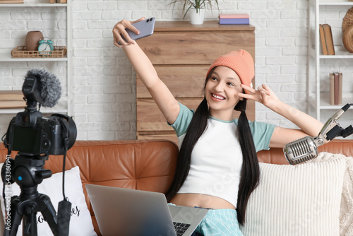 Teenage blogger with mobile...
