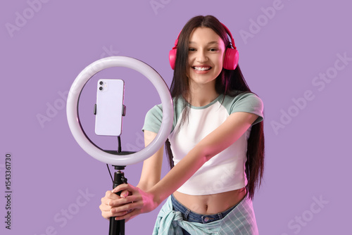 Teenage blogger in headphon...