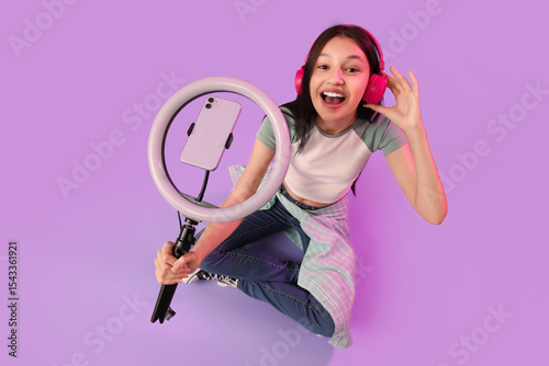 Teenage blogger in headphon...
