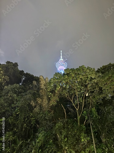 Photography Kuala Lumpur Tower Illuminated at Night, Viewed from Street Level, Malaysia