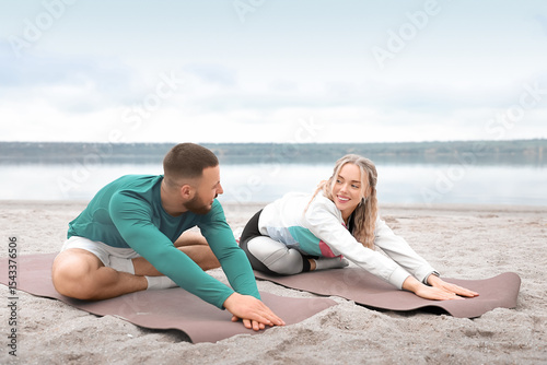 Sporty young couple doing y...