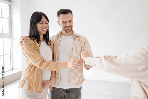 Young couple taking key fro...