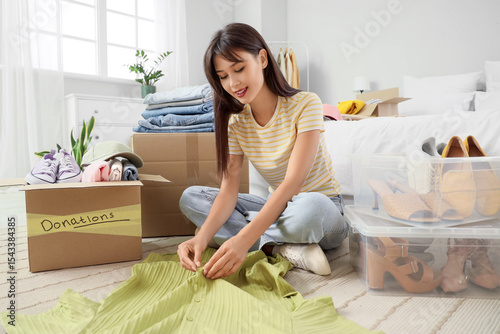 Young woman packing clothes...